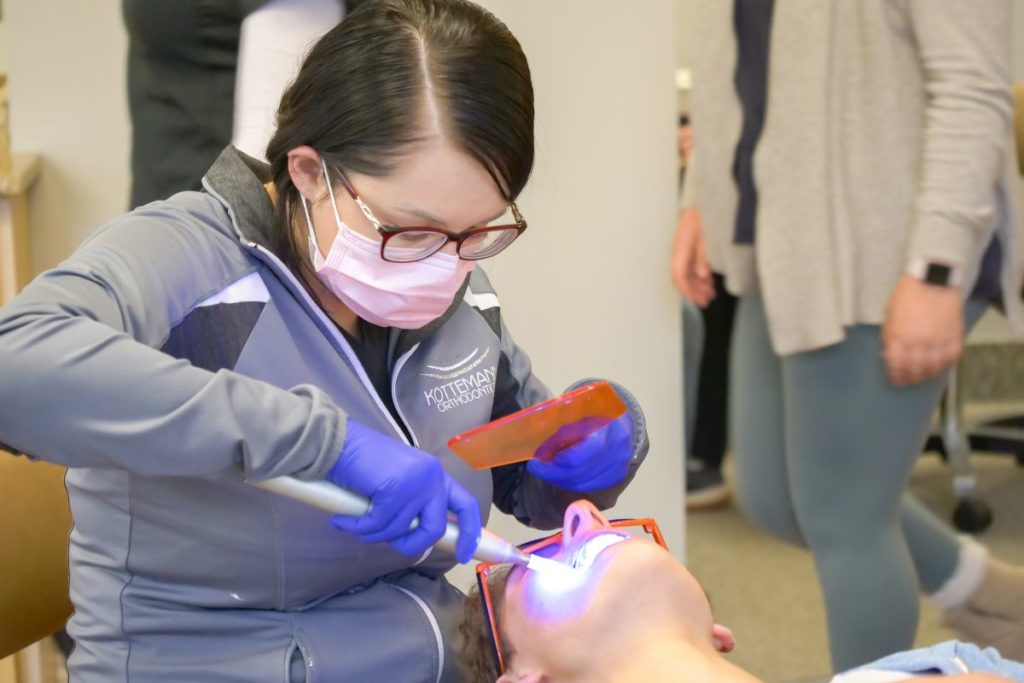 Assistant working on a patient's teeth